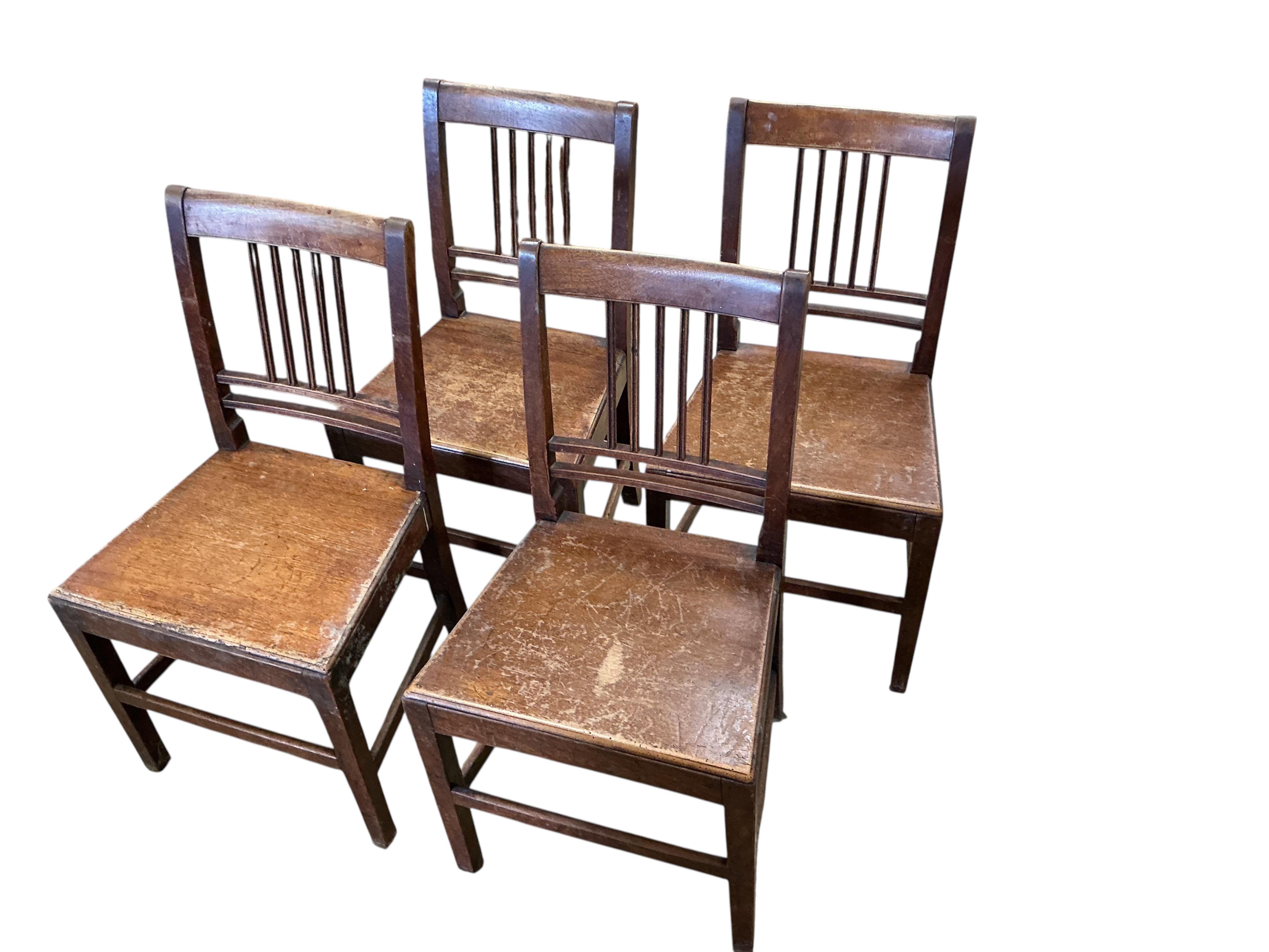 A George III oak drop leaf dining table, width 112cm, depth 42cm, height 71cm together with four George III Provincial mahogany wood seat dining chairs